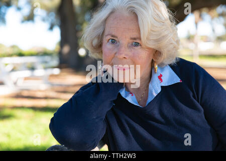 Portrait of a beautiful senior woman in her seventies at a park. Stock Photo
