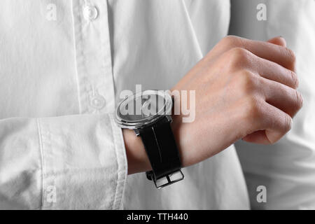 Modern watch on a woman's wrist, close up Stock Photo