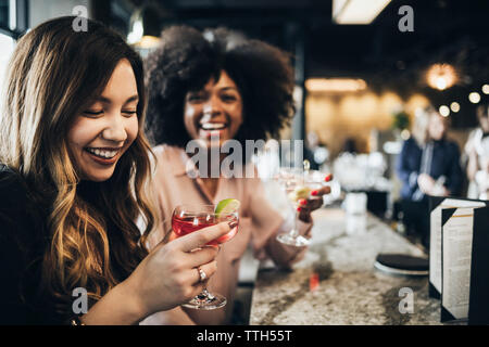 Cheerful businesswomen having drinks in hotel Stock Photo