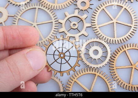 Hand holding gear wheels as the concept of mechanism Stock Photo