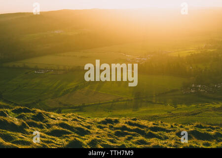 Golden sunset over farm fields Stock Photo