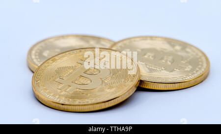 Physical metal golden Bitcoin currency on white background. New worldwide virtual internet money. Digital coin in cyberspace, cryptocurrency gold BTC. Stock Photo