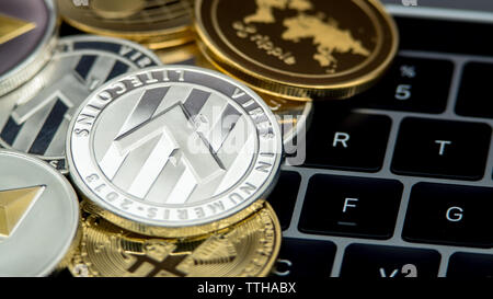 Physical metal silver Litecoin currency on notebook computer keyboard. New worldwide virtual internet money. Digital coin cyberspace, cryptocurrency. Stock Photo