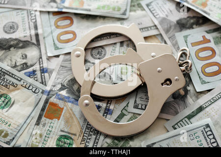 Handcuffs on dollar banknotes. Corruption concept Stock Photo