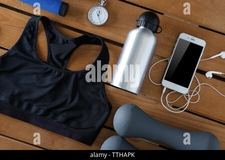 Female sport equipment on a wooden background Stock Photo