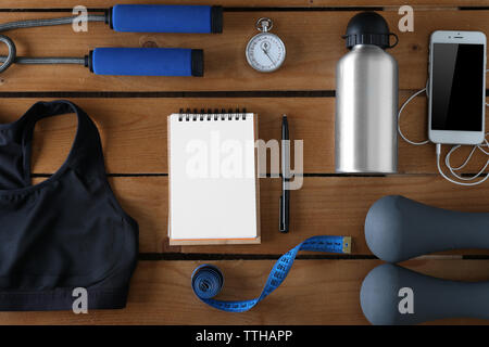 Female sport equipment on a wooden background Stock Photo