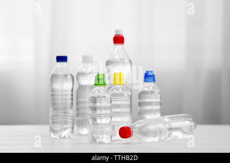 Bottles of water on the white table. Stock Photo