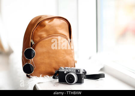 Brown leather backpack on the windowsill. Stock Photo