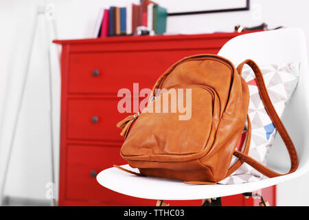 Brown leather backpack on the chair. Stock Photo