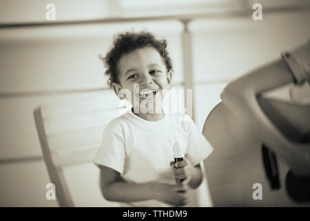 Young girl and little boy playing on music instruments Stock Photo