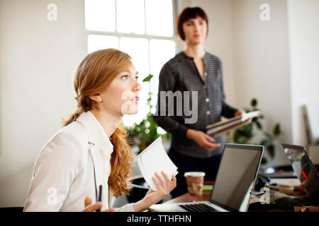 Female photo editors discussing in board room Stock Photo