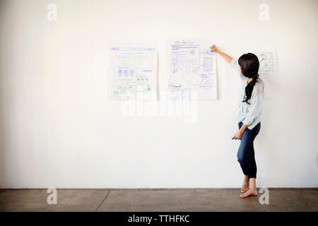 businesswoman drawing on chart in office Stock Photo