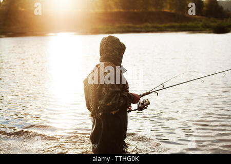 Fishing Poles Mounted on the Holder and Set Up at the Shore of a Lake Stock  Image - Image of outdoor, landscape: 153905367