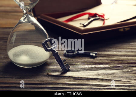 Old keys with envelope on wooden background Stock Photo