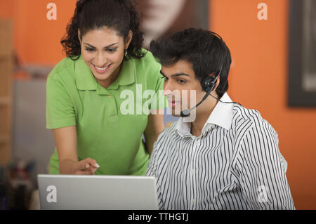 Two business executives working on a laptop Stock Photo