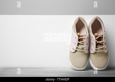 Sneakers for kid on wall background Stock Photo