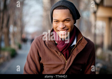 Portrait of cheerful young man wearing knit hat Stock Photo