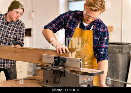 Male carpenter working on wood in workshop Stock Photo