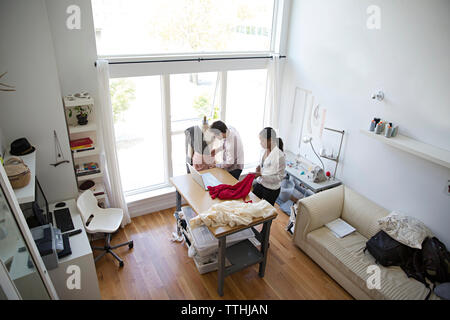 High angle view of fashion designers working at table in studio Stock Photo