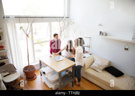 business colleagues having discussion over laptop at table Stock Photo