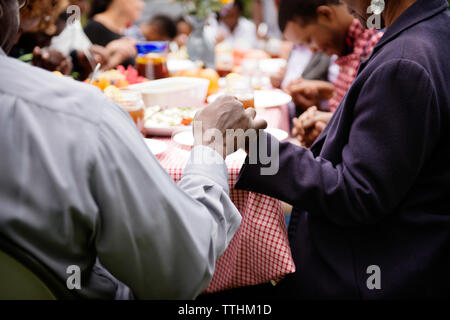 Senior couple holding hands on picnic table Stock Photo