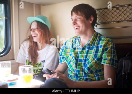 Happy young couple travelling in train Stock Photo