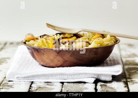 Pasta with oysters served in bowl on table Stock Photo
