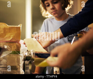 Father and daughter making pasta at home Stock Photo