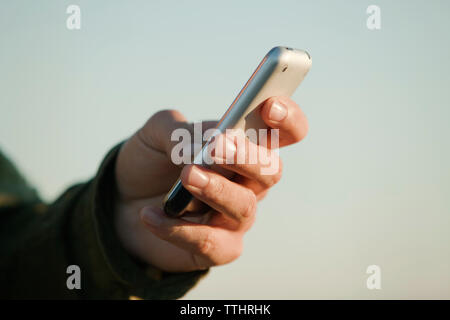 Cropped image of man using mobile phone Stock Photo