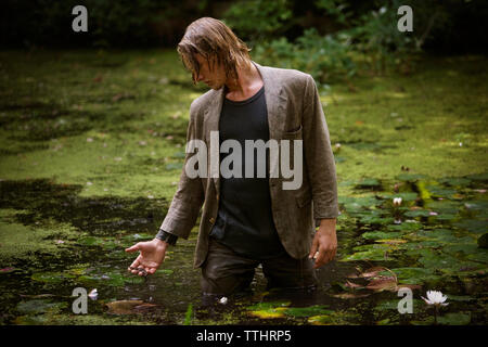 Man standing in swamp Stock Photo