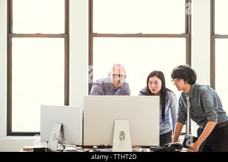 business people looking at computer at office Stock Photo