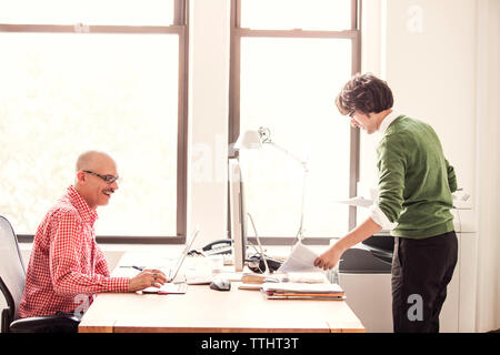 Happy businessmen working at office Stock Photo
