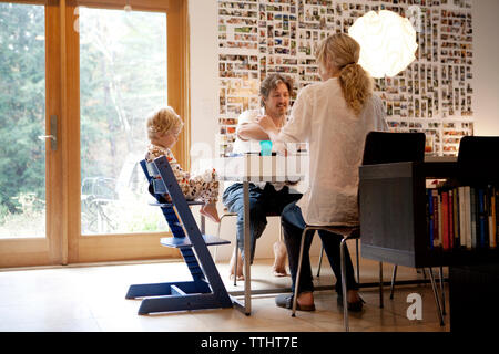 Family having breakfast at table in home Stock Photo