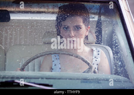 Portrait of woman with short hair sitting in car Stock Photo