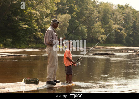 Grandfather and grandson fishing in lake Stock Photo