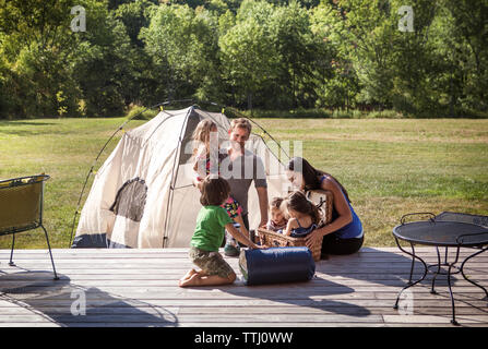 Family enjoying vacation in lawn Stock Photo