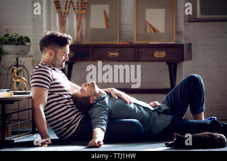 Side view of gay couple sitting at home Stock Photo