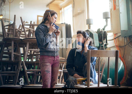 Female carpenters discussing in workshop Stock Photo