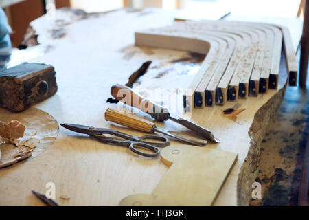 Close-up of wooden planks and tools on workbench Stock Photo