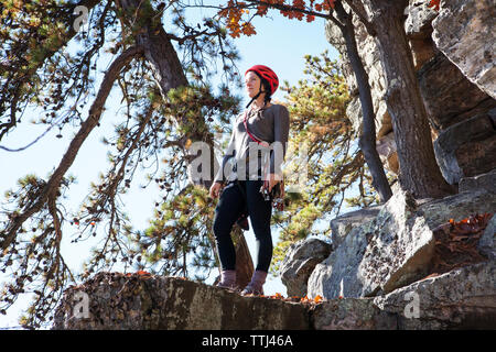 Low angle view of woman standing on rocks Stock Photo