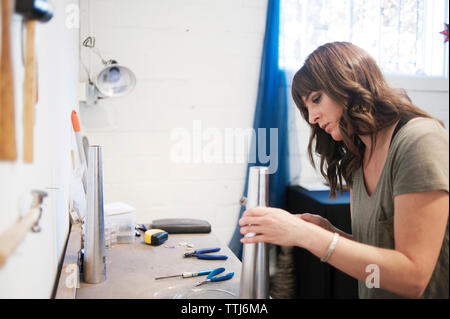 Woman working in workshop Stock Photo