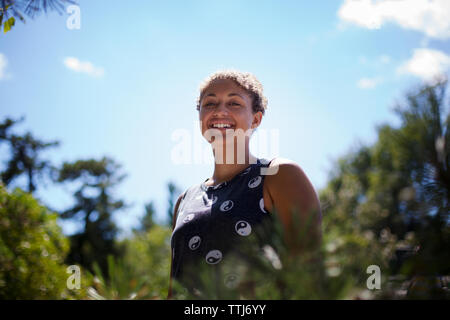 Portrait of cheerful teenage girl against sky Stock Photo