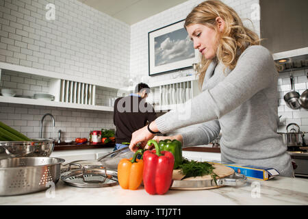 Couple preparing food in kitchen Stock Photo