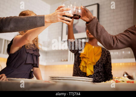 Low angle view of friends toasting wineglasses Stock Photo