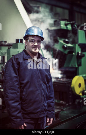 Portrait of smiling man in factory Stock Photo