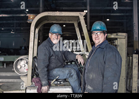 Portrait of happy workers in factory Stock Photo