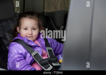 Portrait of cute girl sitting in car Stock Photo