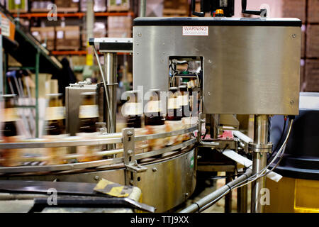 Beer bottles on conveyor belt in brewery Stock Photo