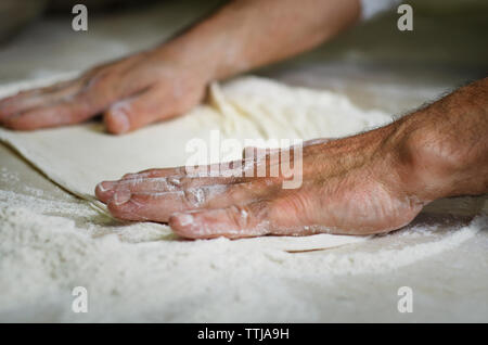 Cropped image of hands making pizza bread Stock Photo