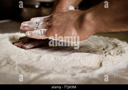 Cropped image of hands kneading dough Stock Photo